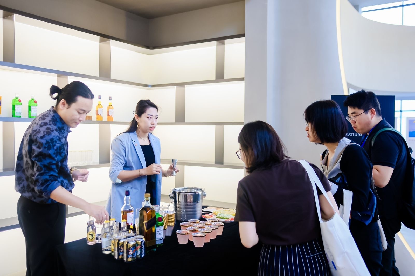 Two expert bartenders from Diageo preparing whiskey cocktails.